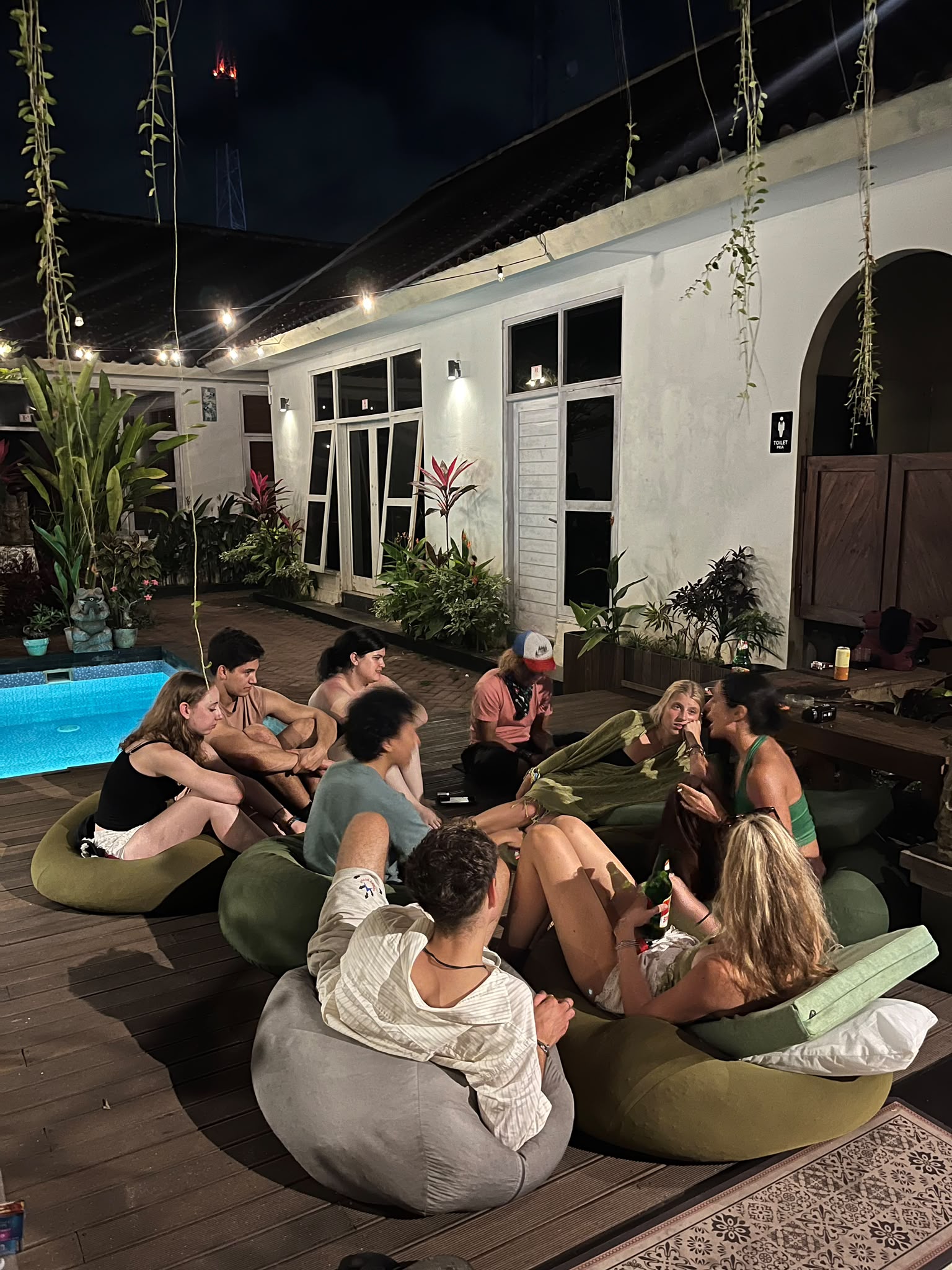 Group of backpackers hanging out next to the pool