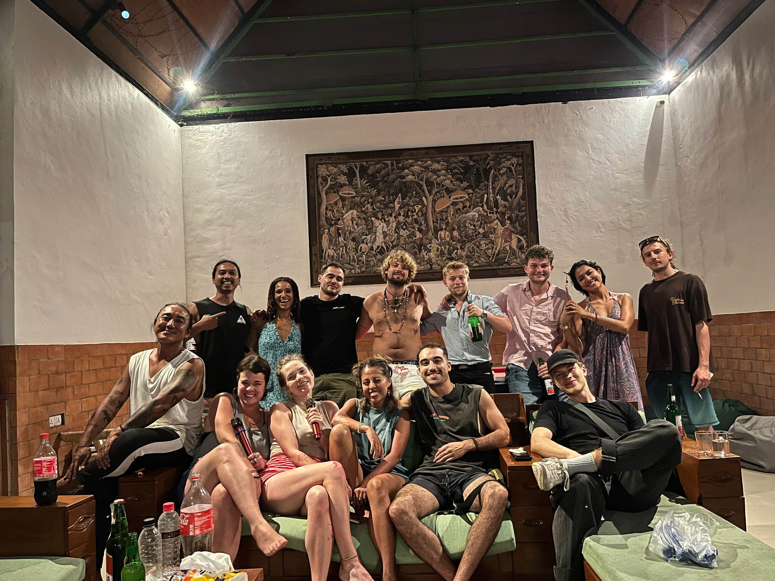Group of backpackers chilling, drinking and taking a group picture.